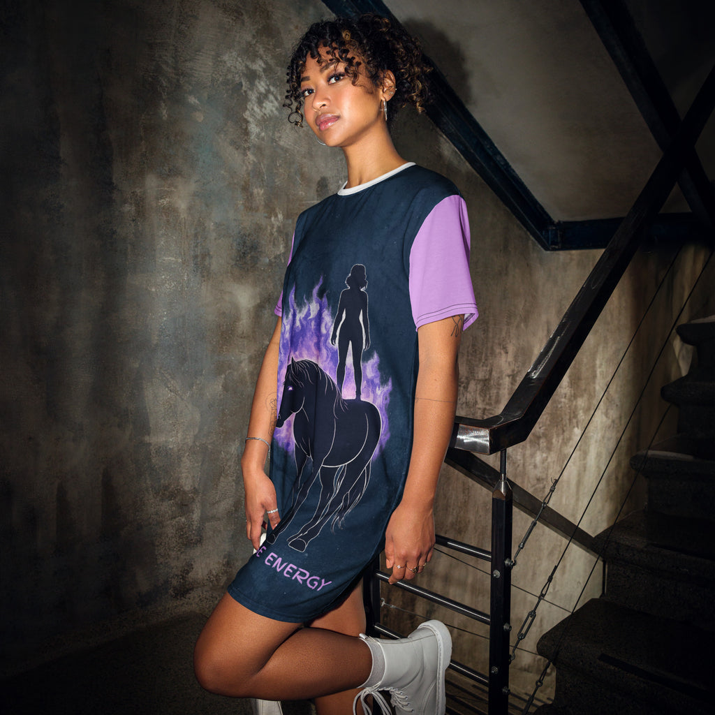 Woman wearing a dress with a horse and energy design in a dark setting