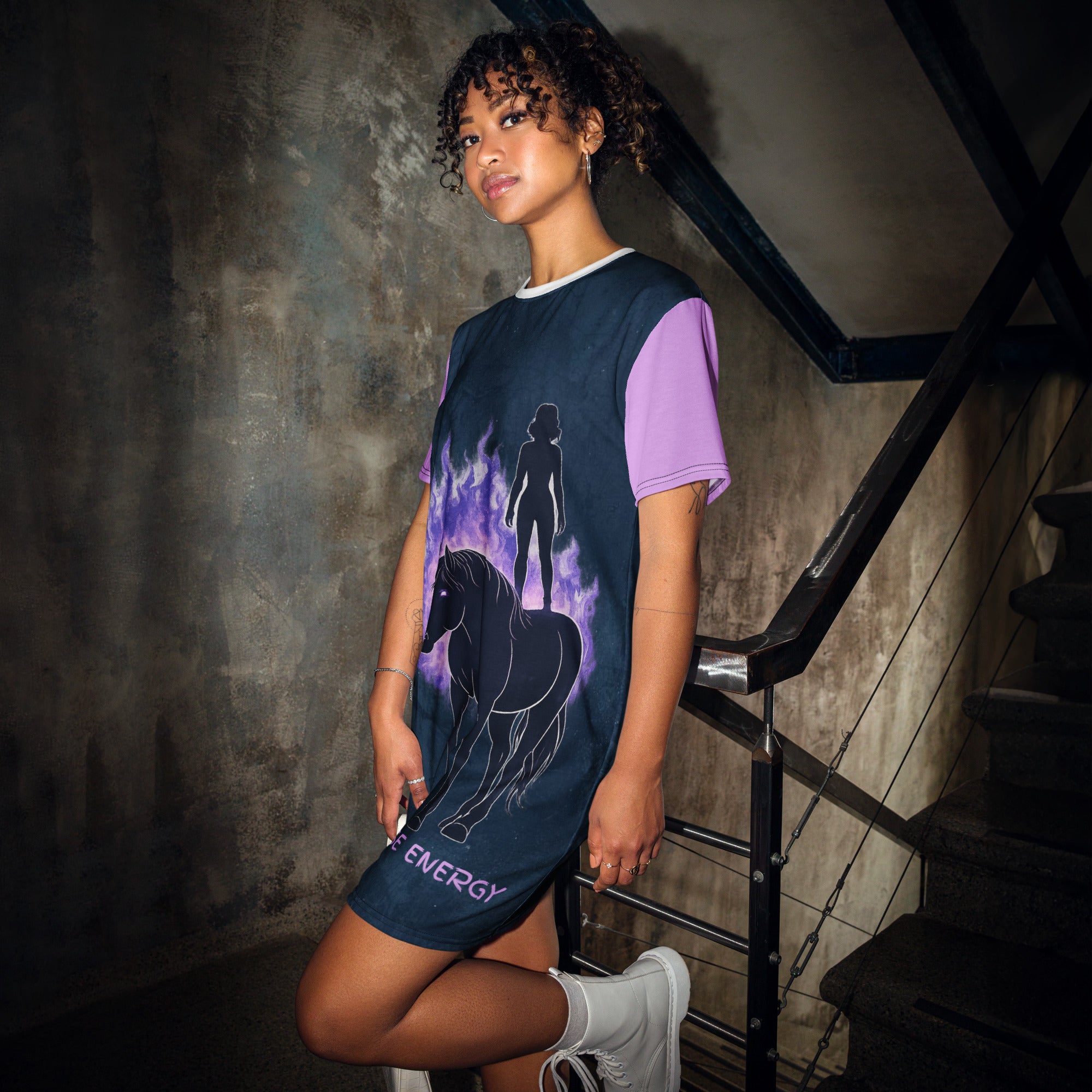 Woman wearing a dress with a horse and energy design in a dark setting